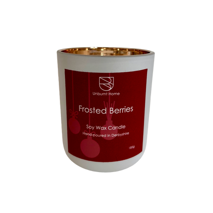 Frosted berries Christmas candle on a white background