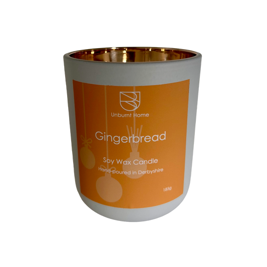 Gingerbread Candle in white jar with gold interior on a white background